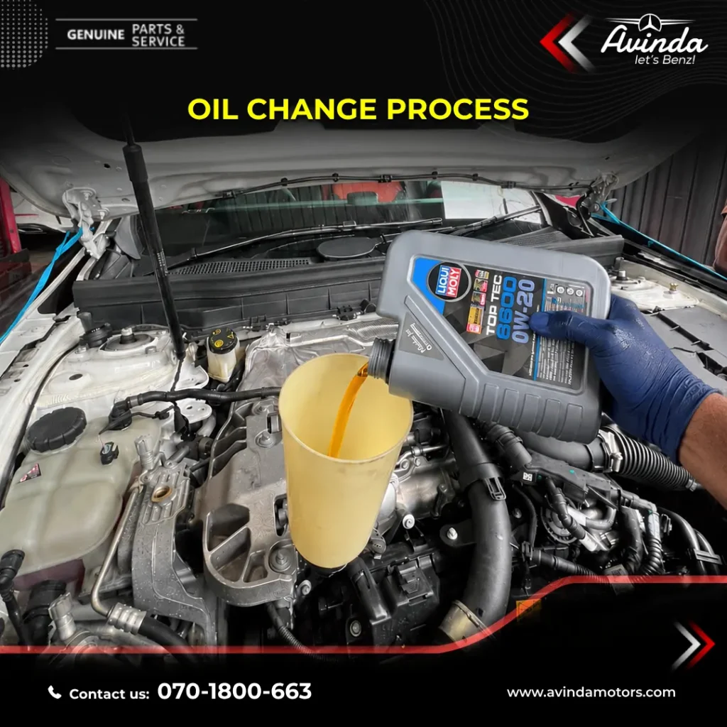 Pouring high-quality German lubricants through a funnel into a Mercedes-Benz luxury vehicle