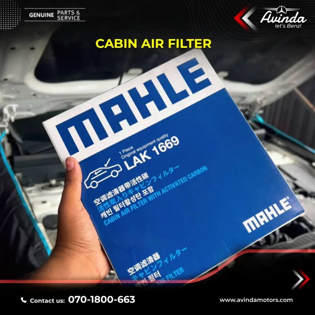 Certified luxury car mechanics replacing the genuine OEM oil filter on a Benz engine